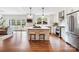 Open kitchen featuring an island, hardwood floors, stainless appliances and seamless access to the living room at 2208 Bay St, Charlotte, NC 28205