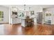 Modern, white kitchen with stainless steel appliances and a central island with seating at 2208 Bay St, Charlotte, NC 28205