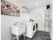 Functional laundry room with washer, dryer, utility sink, and storage at 2208 Bay St, Charlotte, NC 28205
