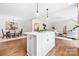 Open living space with hardwood floors, kitchen island, dining room, and comfortable seating at 2208 Bay St, Charlotte, NC 28205