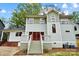 Rear exterior of a two story home with a deck and double red doors at 2208 Bay St, Charlotte, NC 28205