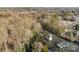 An aerial view displays a home nestled among mature trees in a residential neighborhood at 2706 Booker St, Gastonia, NC 28054