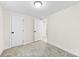 Bright bedroom with carpet floors, white walls, and two doors provides a comfortable retreat at 2706 Booker St, Gastonia, NC 28054