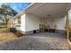 Attached covered carport with parking on a gravel driveway, with stairs leading to an entrance at 2706 Booker St, Gastonia, NC 28054