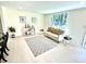 Well-lit living room with a white sofa and a decorative rug, showcasing a cozy ambiance at 2706 Booker St, Gastonia, NC 28054