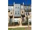 Modern townhouse with a brick and gray exterior, featuring a small balcony and well-maintained landscaping at 2916 Grand Union Way, Charlotte, NC 28209