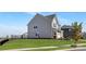 Back exterior view of home with a large fenced yard and manicured lawn at 3013 Whipcord Dr, Waxhaw, NC 28173