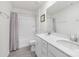 Bathroom featuring double sinks, white cabinetry, and a shower-tub combo with gray tile flooring at 3013 Whipcord Dr, Waxhaw, NC 28173