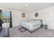 Bedroom featuring gray carpet, full-size bed and windows providing generous natural light at 3013 Whipcord Dr, Waxhaw, NC 28173