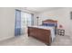 Cozy bedroom with wood frame bed, blue curtains, and natural light at 3013 Whipcord Dr, Waxhaw, NC 28173