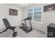 This exercise room has a treadmill, weight bench, dumbbell weights, and a sun-filled window at 3013 Whipcord Dr, Waxhaw, NC 28173