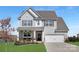 Charming two-story home with light gray siding, white trim, and an attached two-car garage at 3013 Whipcord Dr, Waxhaw, NC 28173