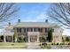 Handsome brick home with stately columns, manicured landscaping, and a welcoming entrance at 3013 Whipcord Dr, Waxhaw, NC 28173