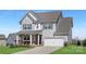 Charming two-story home with light gray siding, white trim, and an attached two-car garage in a desirable neighborhood at 3013 Whipcord Dr, Waxhaw, NC 28173