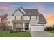 Charming two-story home featuring a well-manicured lawn and inviting front porch at 3013 Whipcord Dr, Waxhaw, NC 28173