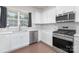 Modern kitchen featuring stainless steel appliances, white cabinetry, and neutral tile backsplash with natural light at 3013 Whipcord Dr, Waxhaw, NC 28173