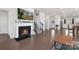 Cozy living room featuring a fireplace, hardwood floors, and staircase, creating a warm and inviting atmosphere at 3013 Whipcord Dr, Waxhaw, NC 28173