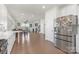 Open-concept living space with hardwood floors connecting the kitchen, dining area, and living room, perfect for gatherings at 3013 Whipcord Dr, Waxhaw, NC 28173