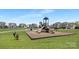 Community playground with multiple slides, a swing set, and a nearby tennis court at 3013 Whipcord Dr, Waxhaw, NC 28173