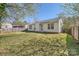 Grassy backyard with a small patio area. The yard is enclosed by a wooden fence at 3023 Fairglen Rd, Charlotte, NC 28269