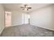 Bedroom features neutral carpet and an adjoining bath at 3023 Fairglen Rd, Charlotte, NC 28269