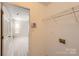 Bright laundry room featuring white walls and gray tiled flooring, offering both functionality and style at 3023 Fairglen Rd, Charlotte, NC 28269