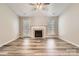 Expansive living room with vaulted ceiling, fireplace, and wood-look laminate flooring at 3023 Fairglen Rd, Charlotte, NC 28269