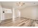 Bright living room with hardwood floors and a ceiling fan at 3023 Fairglen Rd, Charlotte, NC 28269