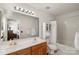 Bright bathroom with double sinks, a soaking tub, and a shower with a curtain at 3048 Misty Harbor Cir # E, Cramerton, NC 28032