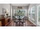 Cozy dining room featuring a glass table, modern chairs, and bright windows at 3048 Misty Harbor Cir # E, Cramerton, NC 28032