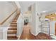 Inviting hallway featuring hardwood floors and an open staircase with natural light at 3048 Misty Harbor Cir # E, Cramerton, NC 28032