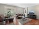 Inviting living room with hardwood floors, leather furniture, and bright natural light at 3048 Misty Harbor Cir # E, Cramerton, NC 28032