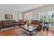 Comfortable living room featuring hardwood floors, plush leather seating, and neutral paint at 3048 Misty Harbor Cir # E, Cramerton, NC 28032