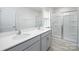 Bathroom with dual vanity, white quartz countertops and glass-enclosed shower at 3052 Ora Smith Rd, Lincolnton, NC 28092
