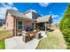 Inviting brick home featuring an outdoor dining set and a covered patio, perfect for entertaining at 324 Kerrydale Ct # 106, Clover, SC 29710