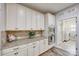 Kitchen area with stainless steel appliances, granite countertops, and convenient access to laundry at 324 Kerrydale Ct # 106, Clover, SC 29710
