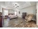 Spacious main bedroom suite featuring a ceiling fan, tray ceiling, and wood-look flooring at 324 Kerrydale Ct # 106, Clover, SC 29710
