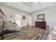 View of main bedroom, showcasing wood-look flooring, and a glimpse into the luxurious bathroom at 324 Kerrydale Ct # 106, Clover, SC 29710