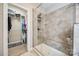 Walk-in shower with a bench seat and tiled walls, adjacent to a walk-in closet at 324 Kerrydale Ct # 106, Clover, SC 29710