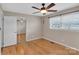 Bedroom featuring hardwood floors, a window, and a mirrored closet for ample storage at 3509 Havenwood Rd, Dallas, NC 28034