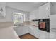 The all-white kitchen features laminate countertops and an eat-in bar at 3509 Havenwood Rd, Dallas, NC 28034