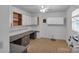 Bright utility room offers built-in desk, overhead cabinets and fluorescent lighting at 3509 Havenwood Rd, Dallas, NC 28034