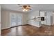 Open-concept living room and kitchen area with hardwood floors and bright white accents and french doors at 3509 Havenwood Rd, Dallas, NC 28034