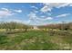 Picturesque backyard with picnic table, wooden structure, and distant view of the outbuilding at 3526 Harmony Hwy, Harmony, NC 28634