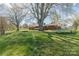 Expansive backyard featuring mature trees and a well-maintained lawn perfect for outdoor activities at 3526 Harmony Hwy, Harmony, NC 28634