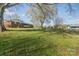 Expansive backyard featuring a large green lawn and mature trees, offering ample space for recreation at 3526 Harmony Hwy, Harmony, NC 28634