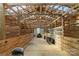 Inside a barn, revealing ample space for storage and work with natural light coming through the structure at 3526 Harmony Hwy, Harmony, NC 28634