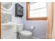 Well-lit bathroom features a vanity and tiled accent wall, creating a clean and functional space at 3526 Harmony Hwy, Harmony, NC 28634