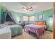Bright bedroom featuring a ceiling fan and two beds, offering a comfortable and inviting space at 3526 Harmony Hwy, Harmony, NC 28634