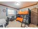 A cozy bunk bedroom with a built-in ladder, a desk and a wardrobe, perfect for maximizing space at 3526 Harmony Hwy, Harmony, NC 28634